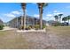 Expansive backyard with a screened lanai and lush landscaping for outdoor enjoyment at 1110 Jasmine Creek Ct, Sun City Center, FL 33573