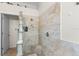 Modern bathroom showcasing tiled shower with glass block accent and coordinated neutral tile at 1110 Jasmine Creek Ct, Sun City Center, FL 33573