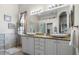 Bathroom with a granite vanity with dual sinks and a large mirror, providing ample space at 1110 Jasmine Creek Ct, Sun City Center, FL 33573