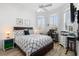 Primary bedroom boasts lots of natural light from windows, ceiling fan, and hard surface floors at 1110 Jasmine Creek Ct, Sun City Center, FL 33573