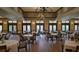 Large dining hall with high ceilings, chandelier lighting, and multiple tables and chairs for large gatherings at 1110 Jasmine Creek Ct, Sun City Center, FL 33573
