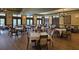 Spacious dining area with elegant chandeliers, tables, and chairs, perfect for gatherings and dining experiences at 1110 Jasmine Creek Ct, Sun City Center, FL 33573
