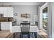 Eat-in kitchen area has neutral paint, white cabinets and sliding door to exterior at 1110 Jasmine Creek Ct, Sun City Center, FL 33573