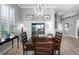 Stylish dining room with a wooden table, modern lighting, and neutral wall color at 1110 Jasmine Creek Ct, Sun City Center, FL 33573