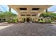 Inviting entrance with covered walkway, brick paving, and manicured landscaping, creating a grand arrival at 1110 Jasmine Creek Ct, Sun City Center, FL 33573