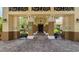 Grand entrance with columns, decorative lighting, and seating, providing a welcoming arrival experience at 1110 Jasmine Creek Ct, Sun City Center, FL 33573