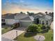 An inviting home features a brick driveway, lush landscaping, and an attached two-car garage for convenient parking at 1110 Jasmine Creek Ct, Sun City Center, FL 33573