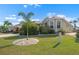 Attractive single-story home with a beautiful front lawn and mature landscaping at 1110 Jasmine Creek Ct, Sun City Center, FL 33573