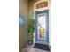 Stylish front door with glass panel and decorative sun ornament for added curb appeal at 1110 Jasmine Creek Ct, Sun City Center, FL 33573
