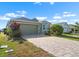 Charming single-story home with a well-manicured lawn and brick paved driveway at 1110 Jasmine Creek Ct, Sun City Center, FL 33573