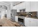 Contemporary kitchen showcases stainless steel appliances, granite countertops, and seamless access to the laundry room at 1110 Jasmine Creek Ct, Sun City Center, FL 33573