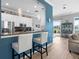 Bright kitchen features white cabinets, granite countertops and a view of the patio at 1110 Jasmine Creek Ct, Sun City Center, FL 33573