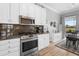 Well-equipped kitchen featuring stainless steel appliances, granite countertops, and views into a bright eating area at 1110 Jasmine Creek Ct, Sun City Center, FL 33573
