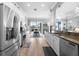 Modern kitchen boasts stainless steel appliances, granite countertops, and a seamless flow to outdoor dining at 1110 Jasmine Creek Ct, Sun City Center, FL 33573