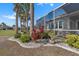 Backyard landscaping with tropical plants and an enclosed patio at 1110 Jasmine Creek Ct, Sun City Center, FL 33573