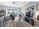Cozy living room with comfortable seating, large windows, and stylish decor at 1110 Jasmine Creek Ct, Sun City Center, FL 33573