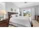 Main bedroom with natural light, ceiling fan, and sliding glass door to exterior at 1110 Jasmine Creek Ct, Sun City Center, FL 33573