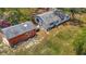 Overhead shot of the rear of a single-story house and red shed on a grassy lot, including a small patio space at 11912 Mcmullen Loop, Riverview, FL 33569