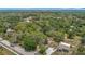 Expansive aerial view of homes amid a lush, green landscape with distant buildings and a clear sky at 11912 Mcmullen Loop, Riverview, FL 33569