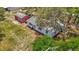 Aerial view of a single-story home plus a detached red storage shed, surrounded by mature trees and a grassy lawn at 11912 Mcmullen Loop, Riverview, FL 33569