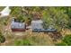 Overhead view of a house and red shed surrounded by green trees, showing a patio and grassy yard at 11912 Mcmullen Loop, Riverview, FL 33569