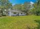 Expansive backyard featuring lush green grass and mature trees, offering ample space for outdoor activities and relaxation at 11912 Mcmullen Loop, Riverview, FL 33569