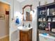 Bathroom with a wooden vanity, large mirror and decorative shelves at 11912 Mcmullen Loop, Riverview, FL 33569