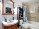 Bathroom with a dark cabinet sink and a shower and tub combo at 11912 Mcmullen Loop, Riverview, FL 33569