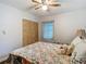 Bedroom showcasing a comfortable bed with a wooden closet and natural light streaming through the window at 11912 Mcmullen Loop, Riverview, FL 33569