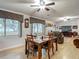 Open dining room featuring wood floors, table and fireplace at 11912 Mcmullen Loop, Riverview, FL 33569