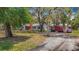 Welcoming single-story home with a brick chimney, complemented by mature trees and a detached garage at 11912 Mcmullen Loop, Riverview, FL 33569