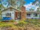 Charming single-story home with a brick chimney and inviting front yard, enhanced by a porch swing at 11912 Mcmullen Loop, Riverview, FL 33569