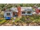 Quaint single-story home with a brick chimney, surrounded by lush greenery, creating a serene setting at 11912 Mcmullen Loop, Riverview, FL 33569