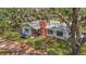 Cozy single-story home with a brick chimney, nestled amid mature trees, providing natural shade at 11912 Mcmullen Loop, Riverview, FL 33569