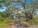 Charming home with a welcoming front porch swing, surrounded by beautiful mature trees and a spacious yard at 11912 Mcmullen Loop, Riverview, FL 33569