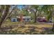 Inviting home with a spacious front yard, mature trees, and an American flag, creating a welcoming atmosphere at 11912 Mcmullen Loop, Riverview, FL 33569