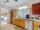 Kitchen featuring stainless steel dishwasher and wood cabinets at 11912 Mcmullen Loop, Riverview, FL 33569