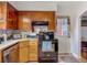 Kitchen with wood cabinets and a black oven at 11912 Mcmullen Loop, Riverview, FL 33569