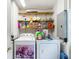Functional laundry room with a washing machine, dryer, and shelving for storage at 11912 Mcmullen Loop, Riverview, FL 33569