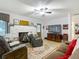 Inviting living room with a stone fireplace, a ceiling fan, and wood floors, creating a cozy atmosphere at 11912 Mcmullen Loop, Riverview, FL 33569