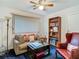 Inviting living room with comfortable seating, a bookshelf, a floor lamp, and natural light at 11912 Mcmullen Loop, Riverview, FL 33569