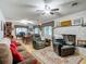 Comfortable living room featuring a stone fireplace, plush seating, and wood floors, ideal for relaxation at 11912 Mcmullen Loop, Riverview, FL 33569