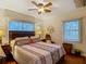 Bedroom featuring a large bed, ceiling fan and two windows at 11912 Mcmullen Loop, Riverview, FL 33569