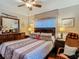 Bedroom with a large bed, mirror, and a ceiling fan at 11912 Mcmullen Loop, Riverview, FL 33569