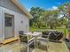 Outdoor patio featuring a four-chair dining table and grill, perfect for relaxing and enjoying the backyard scenery at 11912 Mcmullen Loop, Riverview, FL 33569