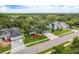 Aerial view of a well-maintained home with a spacious yard and mature trees in a quiet neighborhood at 120 Fernbrook Rd, Oldsmar, FL 34677