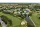 Aerial view of a golf course community with homes nestled among lush greenery and ponds at 120 Fernbrook Rd, Oldsmar, FL 34677
