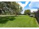 Expansive backyard with lush green lawn and mature trees, offering a serene outdoor space at 120 Fernbrook Rd, Oldsmar, FL 34677