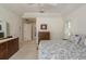 Light, bright, and airy bedroom featuring neutral carpet, a ceiling fan, and standard closet with an en-suite bathroom at 120 Fernbrook Rd, Oldsmar, FL 34677