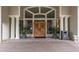 Grand entryway to the Ardea Country Club with impressive carved wooden doors and stately columns at 120 Fernbrook Rd, Oldsmar, FL 34677